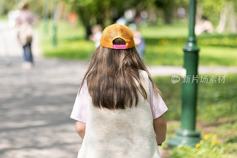 Young girl on scooter in park